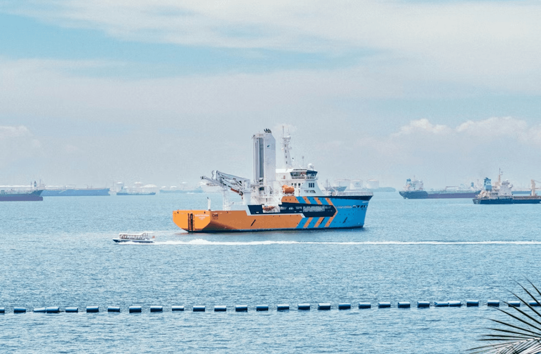 Logistics worker in orange safety vest performing inspection
